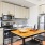 well lit kitchen with island table